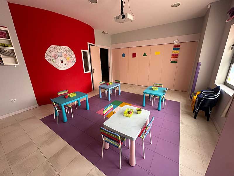 Aula infantil con mesitas y sillas